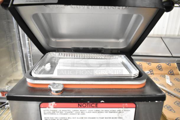 2023 Nemco 6625B Fresh-O-Matic Countertop Rethermalizer displayed open, showing heating tray and instruction manual.