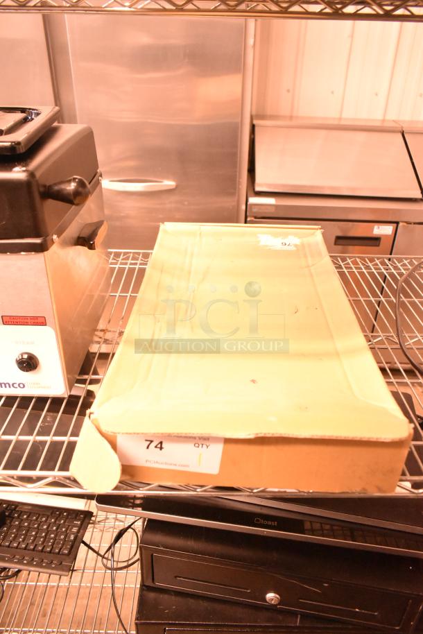 Brown cardboard box labeled with "74," containing a new Dorman 740-404 Window Regulator, visible shelf storage in background.