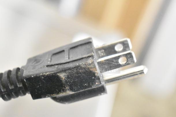 Close-up of a worn electrical plug from the 2023 Automatic Bar Controls JT-NITCOM-L Nitro Dispenser. 115V, 1 Phase.