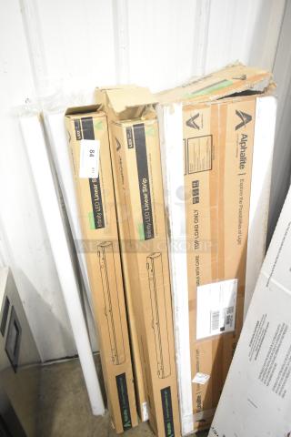 7 brand new Alphalite Infinity LED Linear Strips in boxes with minor scratches and dents. Boxes labeled for care.