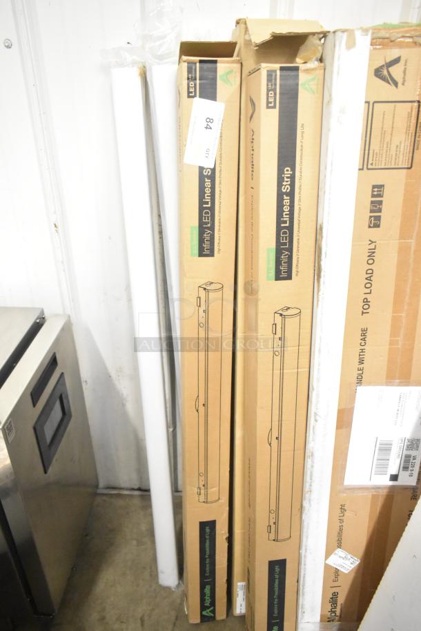 7 new Alphalite Infinity LED Linear Strips in original boxes. Some boxes show scratches and dents.