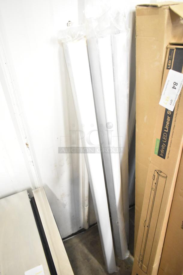 7 new Alphalite Infinity LED Linear Strips, scratch and dent condition, in packaging, labeled for auction.