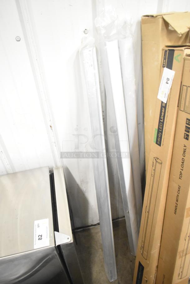 7 Alphalite Infinity LED Linear Strips, brand new with scratch and dent marks. Original packaging visible.