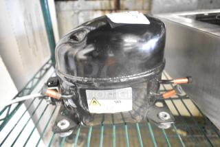 Cubigel NUT55NR compressor, black, 151-127 volts, 1 phase, showing label and copper fittings.