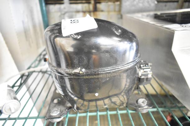 Cubigel NUT55NR Compressor, black, 151-127 volts, 1 phase, appears in good condition with label attached.