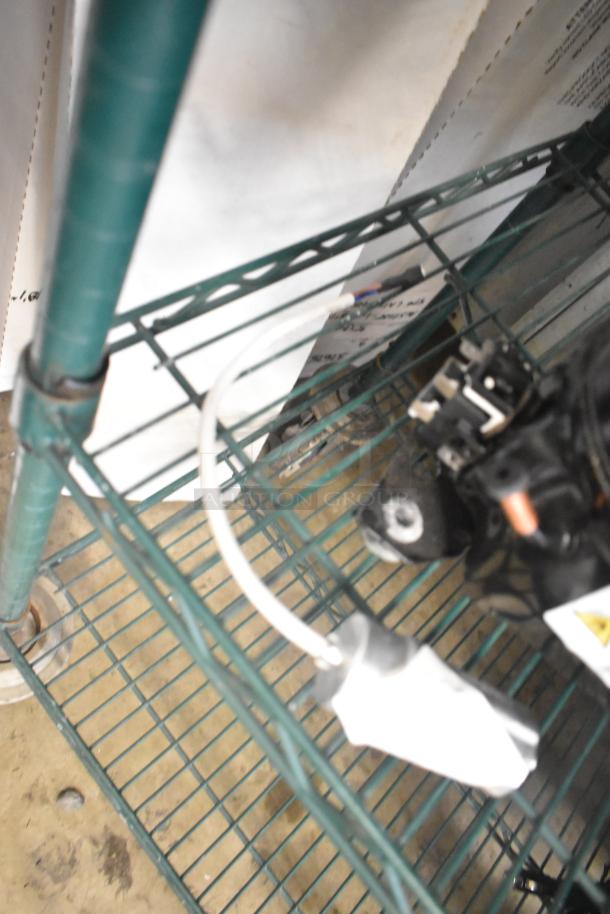 Cubigel NUT55NR Compressor on metal shelf, 151-127 volts, 1 phase, used condition, with visible wiring and components.