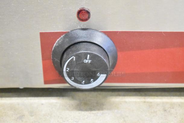 Close-up of the knob and indicator light on a Brand New Scratch and Dent Avantco 177FW200D food warmer.