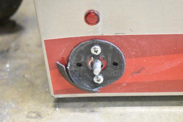 Close-up of a damaged control knob on a 2025 Avantco 177FW200D food warmer. Visible scratches and red indicator light.