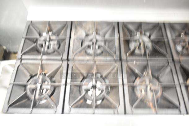 Mainstreet 541E60N 10-burner natural gas range with grills, showing used condition and back splash.