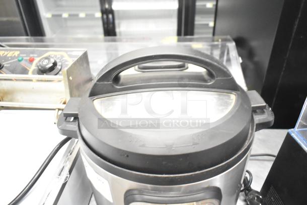 Instant Pot Duo 80 v5 electric pressure cooker, visible lid, and handle. Model tags indicating 120 volts, 1 phase.