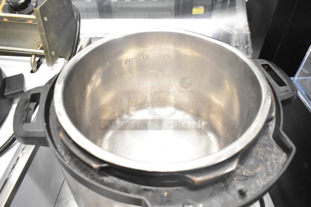 Instant Pot Duo 80 v5 electric pressure cooker, stainless steel insert visible, model markings, lightly used condition.