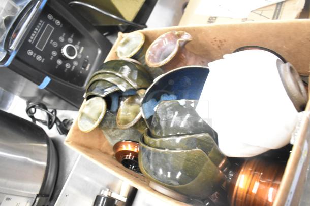 Lot including various ceramic bowls, vases, and poly trays in a cardboard box. Items appear in good condition.