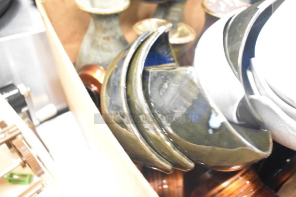 Lot of ceramic bowls and vases with poly trays in a box. Items show mixed colors and patterns, indicating diverse styles.