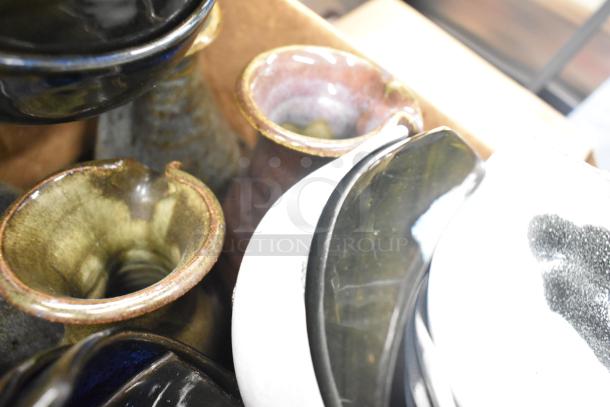 Lot of various items including ceramic bowls, vases, and poly trays. Features mixed textures and colors. Condition varies.
