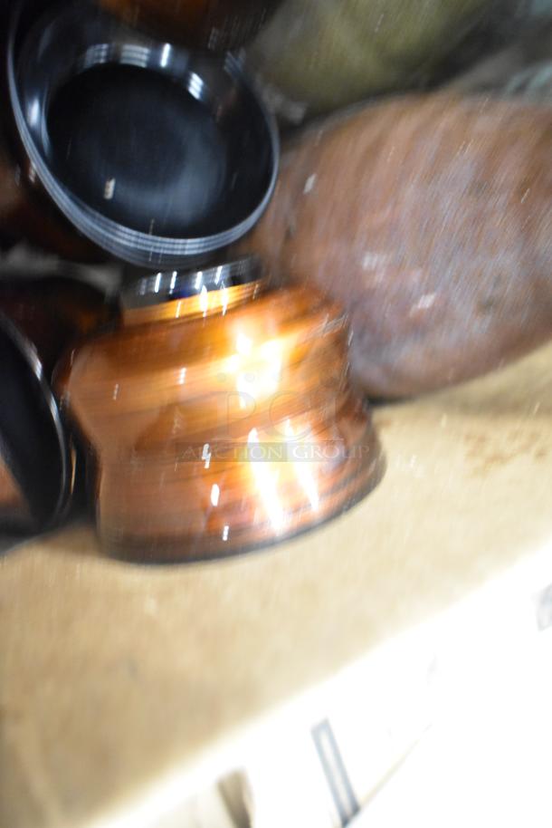 Lot of various items including ceramic bowls, vases, and poly trays. Items are stacked and may have wear.