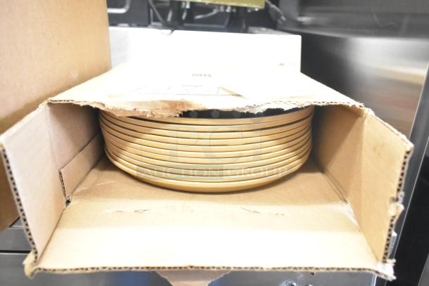Cardboard box containing stacked yellow ceramic bowls, showing moderate wear. Part of a mixed item auction lot.