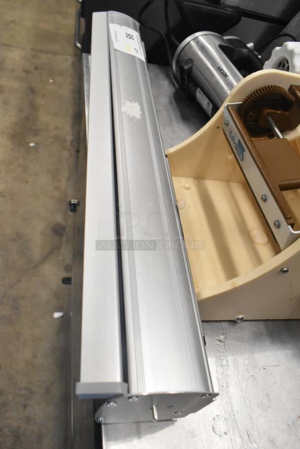 Four items including an Antree meat grinder attachment and an Aicok HM833 hand blender, shown on a metal surface.