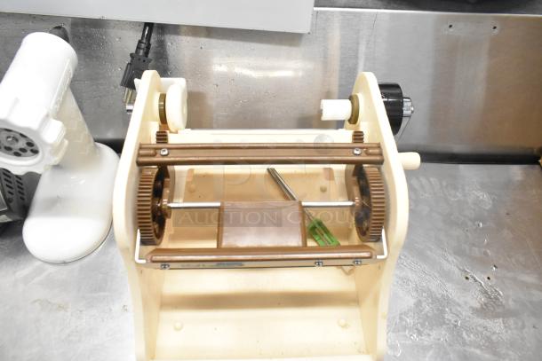 Antree Meat Grinder Attachment, Aicok HM833 Hand Blender and two unknown items in used condition on a metal surface.