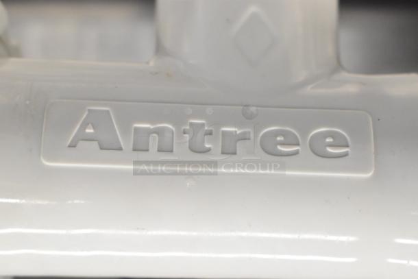 Antree meat grinder attachment with embossed brand logo; durable white plastic construction; part of auction lot.