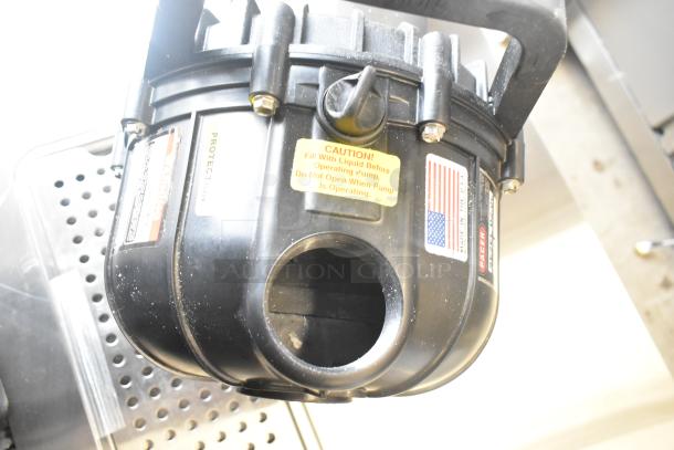 Pacer Baldor SuperE Motor, 230/460V, 3 Phase. Black, handle on top, caution label warns “Fill with liquid before operating pump.” Made in USA flag sticker.