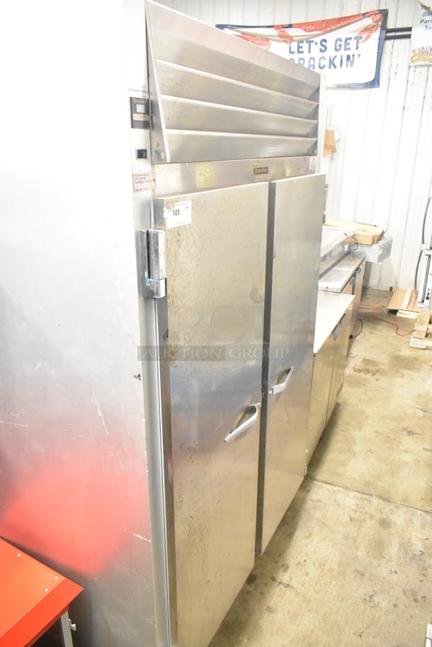 Traulsen G20010 commercial 2-door reach-in cooler, stainless steel, visible wear, 115 volts, 1 phase, industrial use.