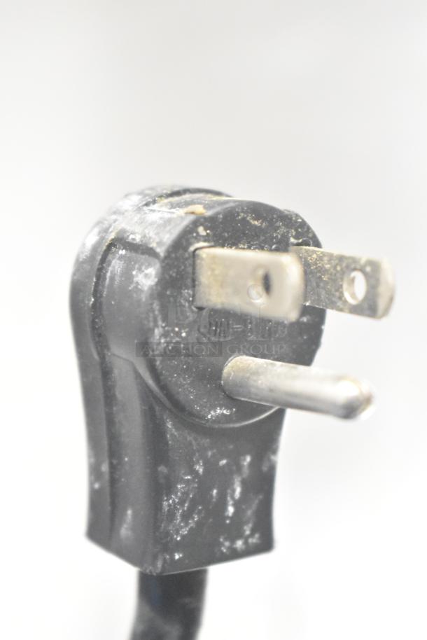Power plug for Traulsen G20010 Commercial Cooler, 115 volts, 1 phase, shows signs of wear.