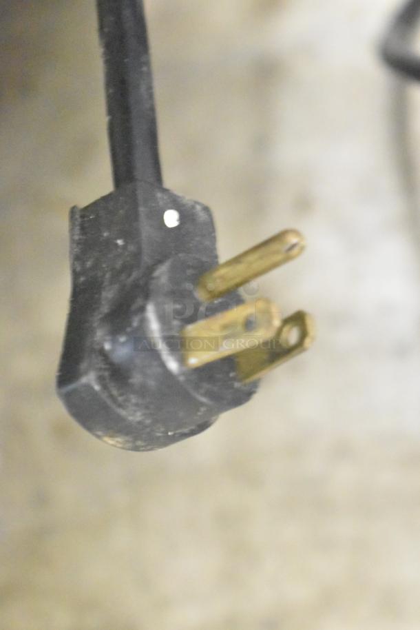 Close-up of a three-prong plug from a Beverage Air WTR60A commercial undercounter cooler. Plug appears used.