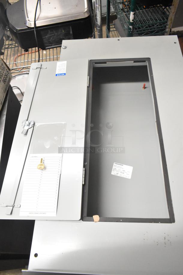 Metal cabinet with bracket hinge sets, features circuit directory and label, in good condition. Includes lock and key.