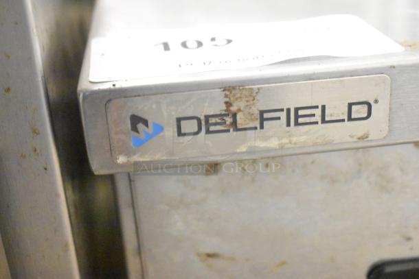 2018 Delfield 406P-STAR4 undercounter cooler, single door, visible wear, Delfield logo, 115V, 1 phase, commercial use.