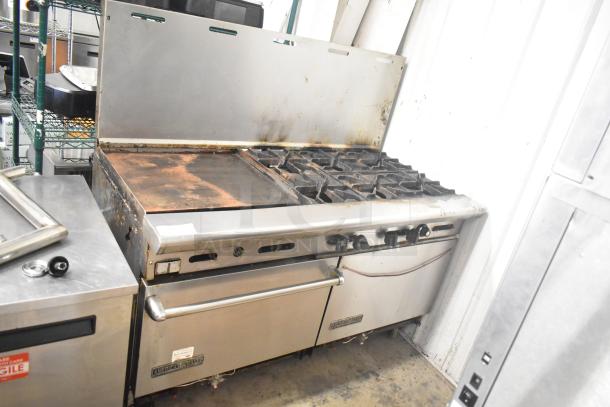 American Range commercial gas 6-burner range with flat top griddle, two ovens, and backsplash, well-used condition.