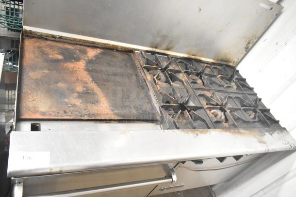 American Range commercial gas 6-burner range with flat top griddle, 2 ovens, and backsplash; used condition, visible wear.