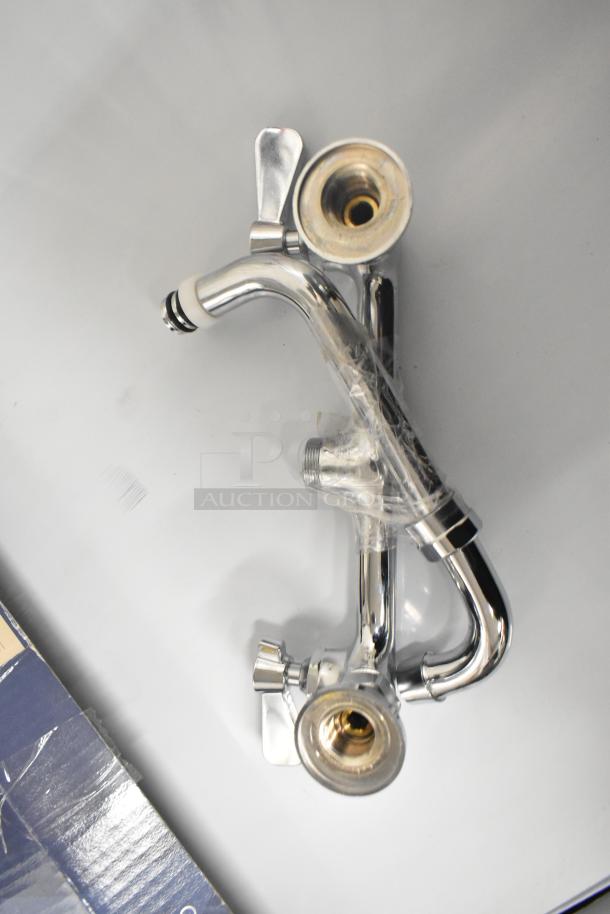 Brand new Waterloo 750AF14 pre-rinse add-on faucet, 14", chrome, minor scratches, dual handles, wrapped for protection.