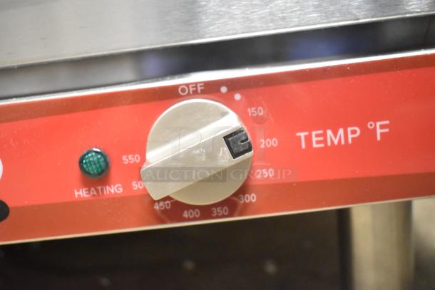 Avantco 177CO28M convection oven control panel close-up, showing temperature dial and heating indicator light.