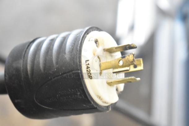 Close-up of a black power plug with brass prongs labeled L1420P, part of the Bunn CWTF35-APS Airpot Brewer.