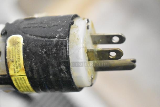 Close-up of Patriot FMFW-1200W Food Warmer plug. Visible wear, label indicating circuit tester. 120 Volts, 1 Phase.