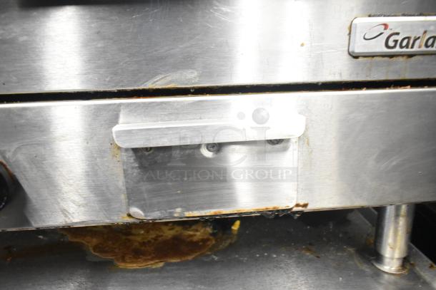 Garland E24-36G Commercial Electric Griddle, stainless steel, signs of wear, logo visible, 208V, 1/3 phase.