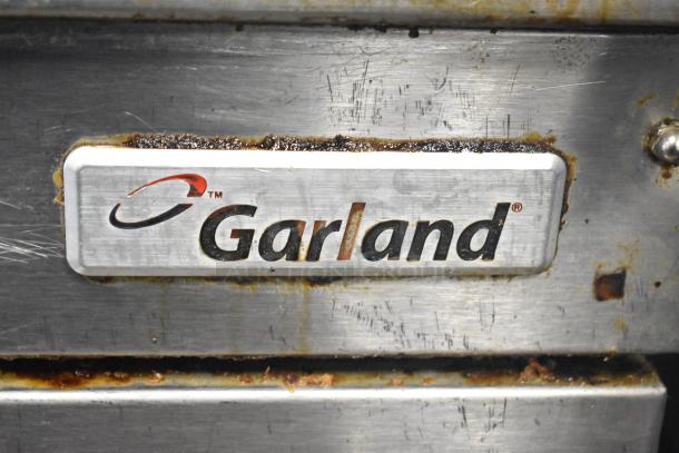 Garland E24-36G electric countertop griddle, visible wear, 208V, 1/3 phase. Features Garland logo plate.