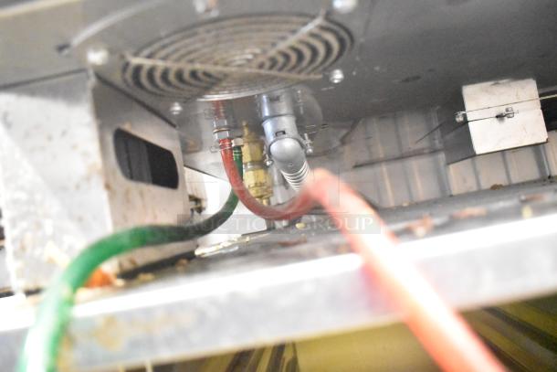 Underside view of Convotherm C4eD6.20ES-N oven, showing wiring and connections. Stainless steel build, for commercial use.