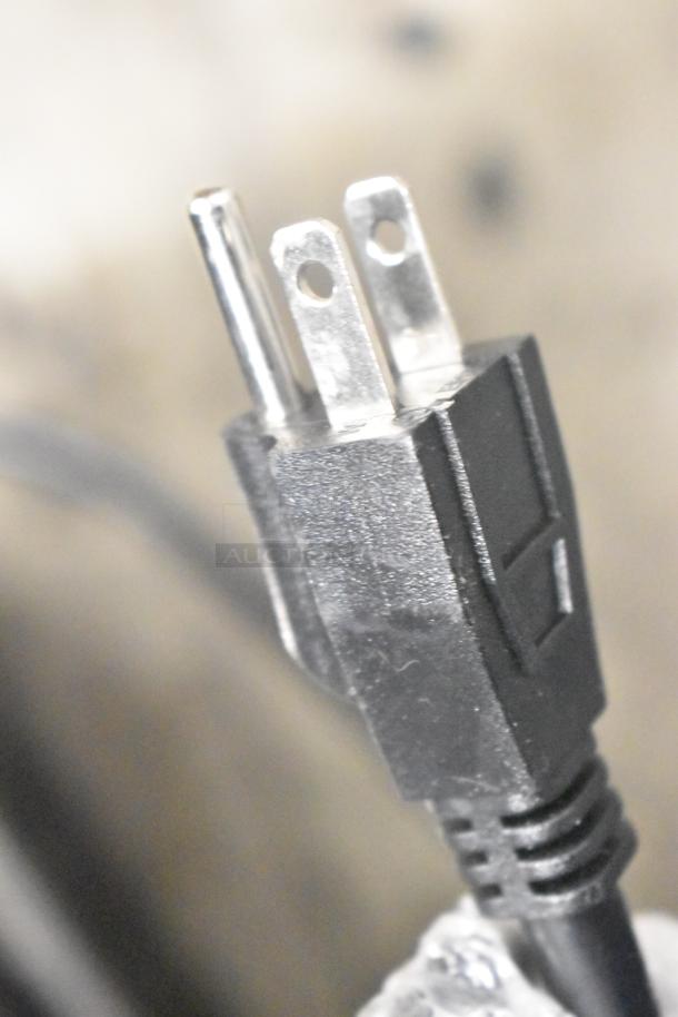 Close-up of a three-prong black power plug for the Avantco 177HDC26 heated display case.