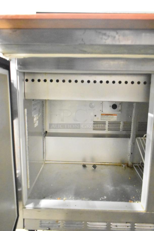 Beverage Air commercial prep table interior, showing storage space and shelves, set on commercial casters, 115V, 1 phase.