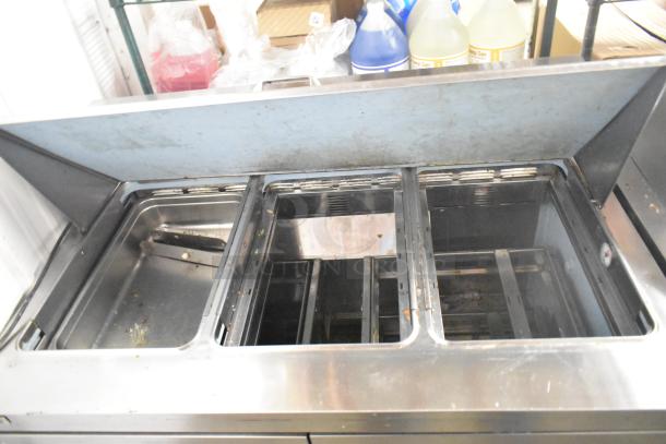 Delfield D4448N-18M-A22 sandwich prep table, stainless steel, Bain Marie top, four drawers, 115V, visible wear.