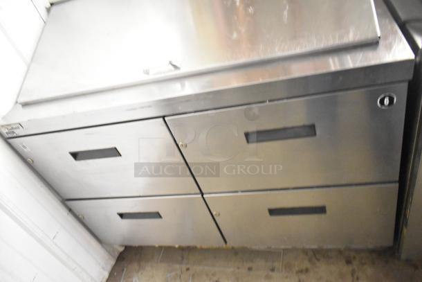 Delfield D4448N-18M-A22 sandwich salad prep table with 4 drawers. Stainless steel, used condition. Model label visible.