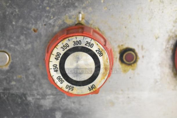 Lang 48T griddle thermostat dial, showing temperature range 200-550 degrees. Visible wear, indicative of usage.