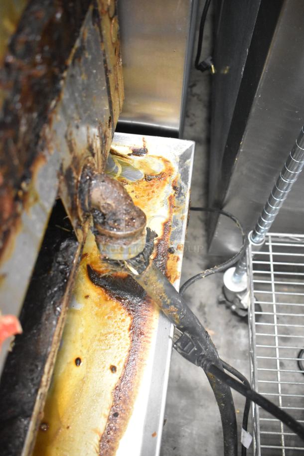 Lang 48T commercial electric griddle surface close-up, showing signs of heavy use with grease buildup.