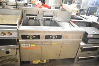 Frymaster 2-bay deep fat fryer with dumping station, filtration system, and commercial casters. Used condition.