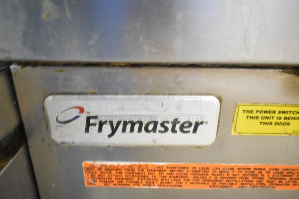Frymaster commercial 2-bay deep fat fryer with dumping station and filtration system, branded label visible, on casters.