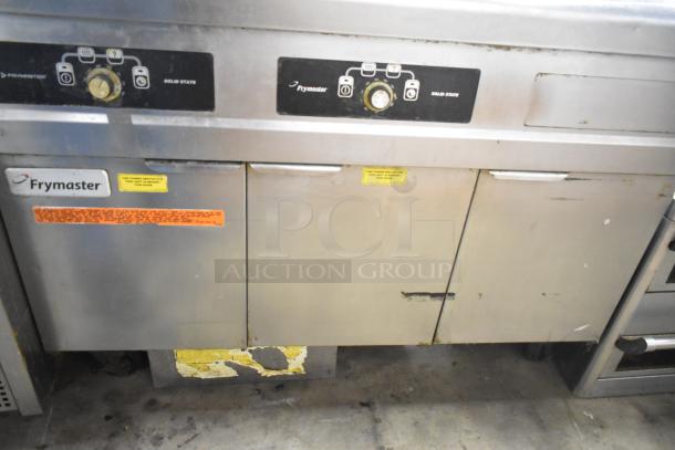 Frymaster 2 Bay Deep Fat Fryer with dumping station and filtration system on casters, shows wear, various control labels.