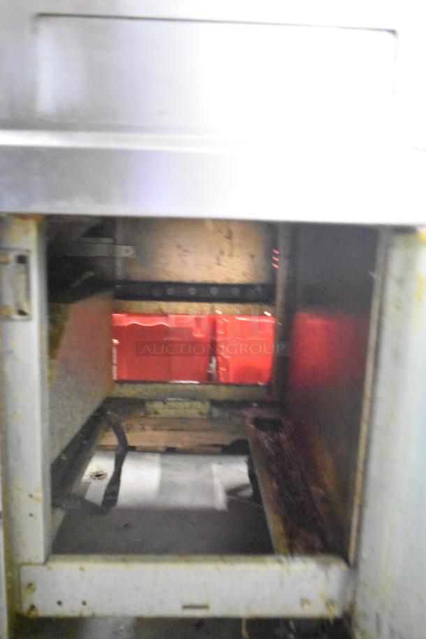 Frymaster 2-bay deep fryer with dumping station and filtration system on casters, showing wear and signs of use.