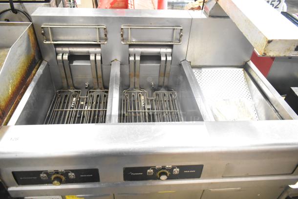 Frymaster commercial 2-bay deep fryer with dumping station and filtration system, on casters. Good condition.