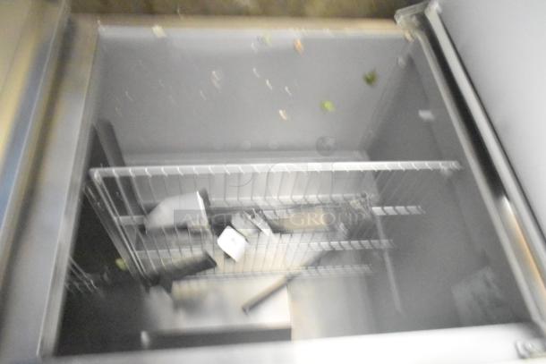 2024 Delfield 4460NP-24M sandwich salad prep table, mega top design, internal wire shelving, visible signs of use.